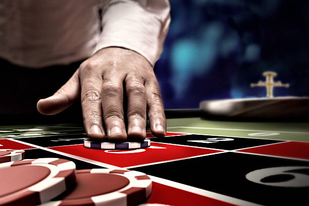 gambler bet on roulette number hand betting on roulette number at casino table roulette photos stock pictures, royalty-free photos & images
