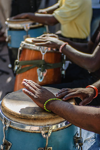 Dance music by drumming on Bongo drums in Cuba Three pairs of hands creaing salsa dance music by drumming on large bongo drums in Cuba salsa music photos stock pictures, royalty-free photos & images