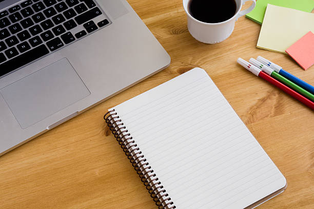istock Notebook on the wooden background with a cup of coffee 636242236