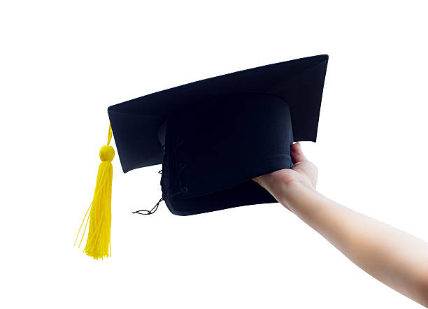 istock hand holding graduation hats isolated on white background 636242310