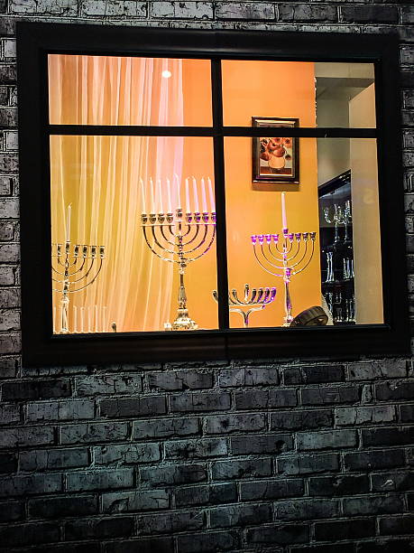 Tel Aviv, Israel - December 22, 2016: Showcase of Judaica store before the Hanukkah holiday with exposed different sizes and designs menorahs (traditional candelabra)