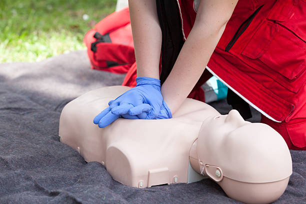 Paramedic demonstrate Cardiopulmonary resuscitation (CPR) on dummy First aid training. Instructor showing CPR on training doll. first aid class stock pictures, royalty-free photos & images