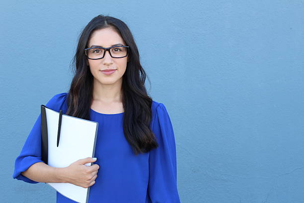Stock image of female college student isolated Stock image of female college student isolated on blue background. mediterranean woman portrait stock pictures, royalty-free photos & images