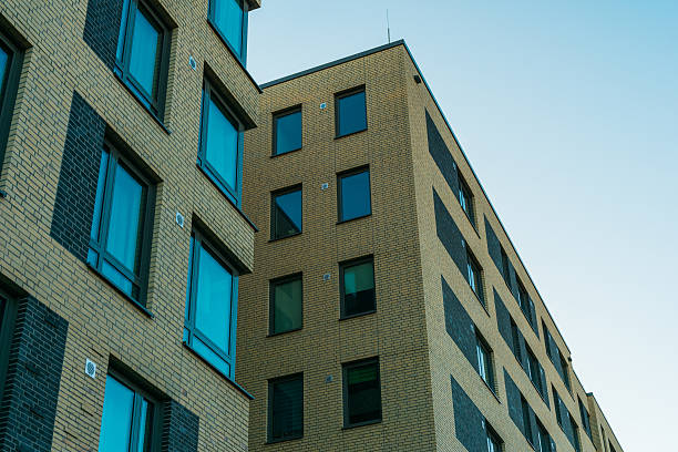 istock big and modern apartment buildings with blue windows 636244480
