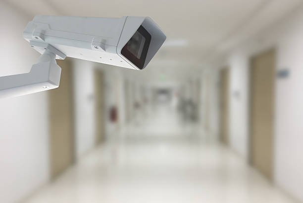 istock cctv camera with  hospital hall way in background 636245342