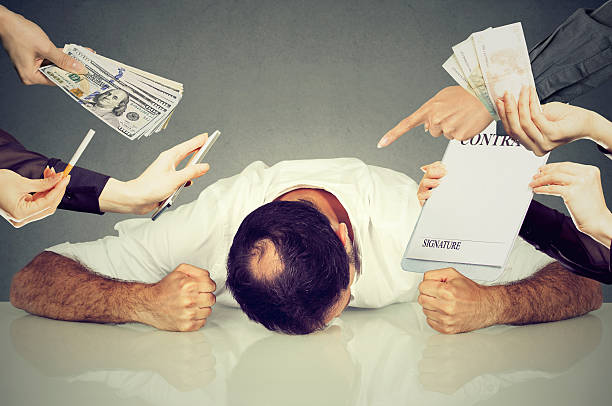 istock Tired stressed man overwhelmed by things to be done 636245620
