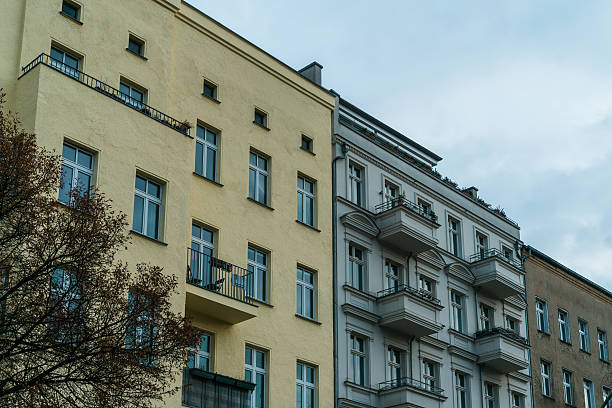 istock yellow, white and brown houses in a row 636245664
