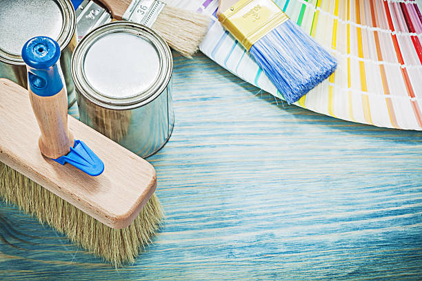 istock Paint cans brushes colour sampler on wooden board construction conc 636247384