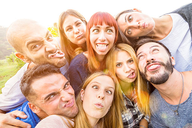 istock Happy best friends taking fun selfie outdoor with back lighting 636247634