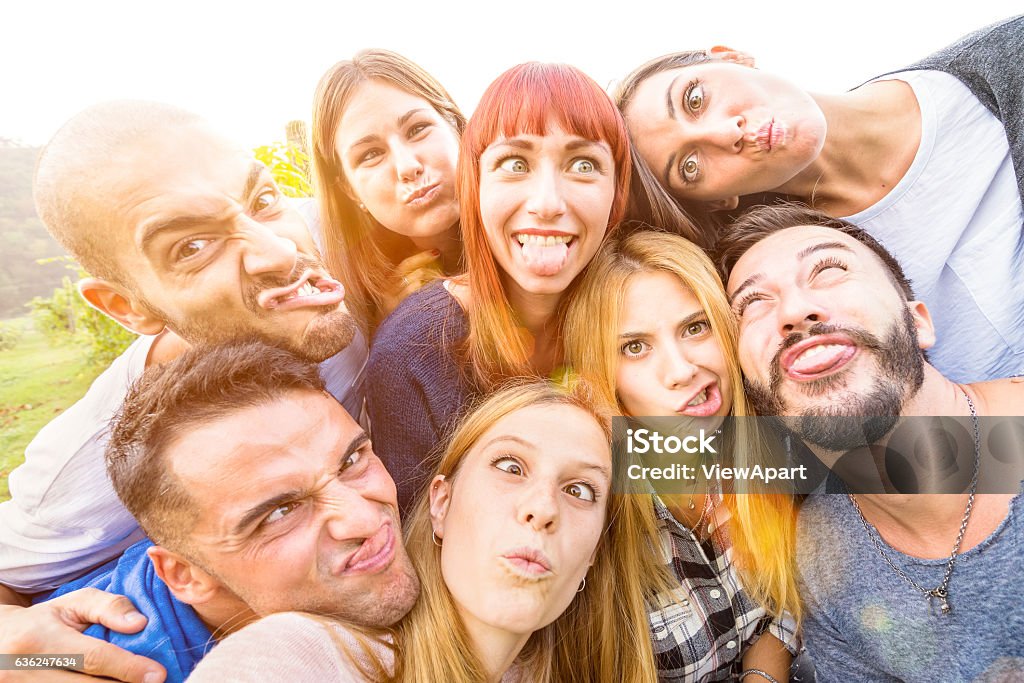 Happy best friends taking fun selfie outdoor with back lighting Best friends taking selfie outdoor with back lighting - Happy youth concept with young people having fun together - Cheer and friendship at picnic - Warm vivid filter with focus on redhead woman Friendship Stock Photo