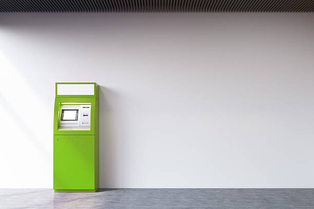 istock Green ATM machine near concrete wall 636248018