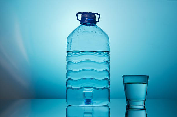 istock Big Bottle Of Water with glass 636250308