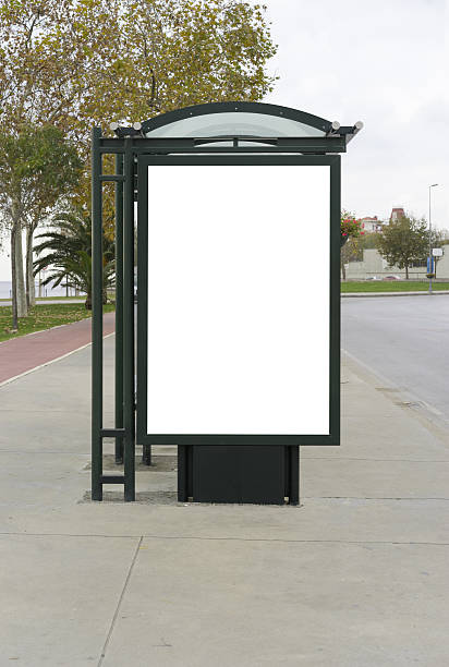 istock Blank white mockup of bus stop billboard in empty street. 636250506