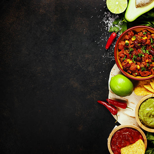 Mexican food Mexican food concept: tortilla chips, guacamole, salsa, chilli with beans and fresh ingredients over vintage rusty metal background. Top view fajita photos stock pictures, royalty-free photos & images
