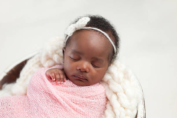 Newborn Baby Girl Sleeping in Bowl stock photo
