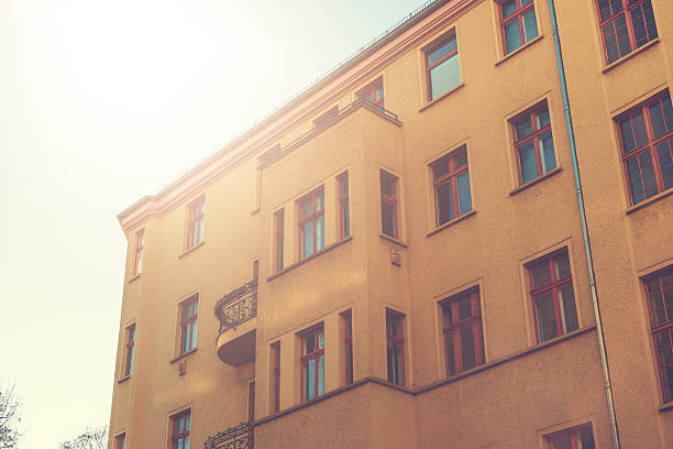 istock orange apartment building in autumn sunlight 636254360