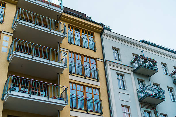 istock orange and white facades with balcony 636254470