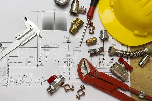 istock Office desk with hydraulic fittings, helmet  and project design 636254610