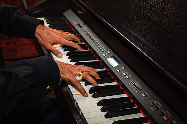 Male Asian Hands on Digital Piano Keyboard