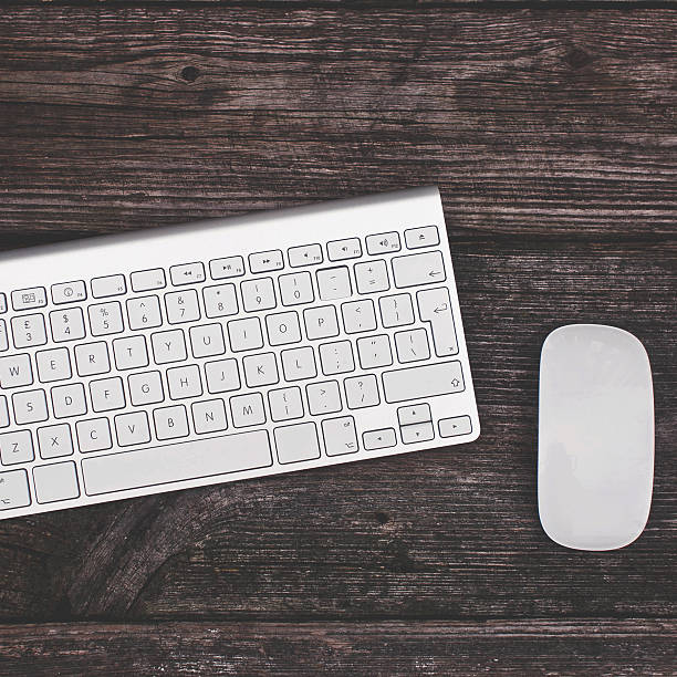 istock mouse and keyboard on a wooden background 636258742