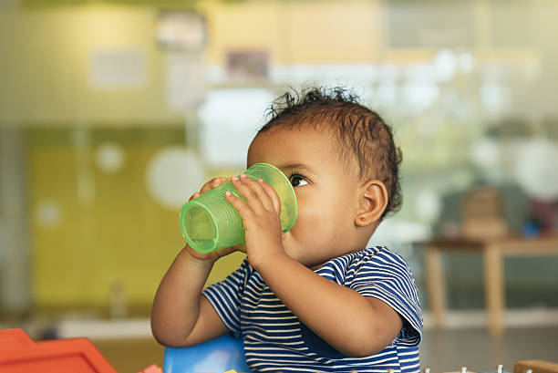 istock Happy baby drinking water and playing. 636259226