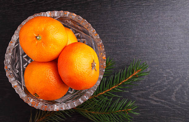 istock Tangerine in a metal basket with a branch 636259442