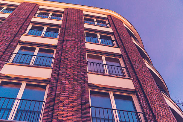 istock low angle view of brick facade in the afternoon 636260506