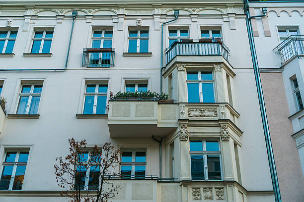 istock low angle view of beautiful facade with blue windows 636260564
