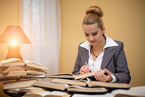 istock Business laywer woman write notes on book in office 636260724