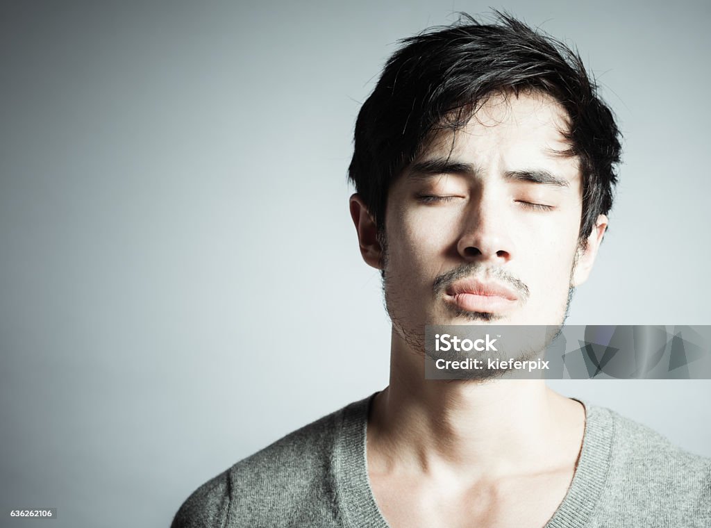 Sadness Sad young man. Isolated in the studio.  Men Stock Photo