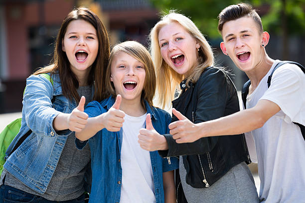 istock Girls and boys posing with thumbs up 636264596