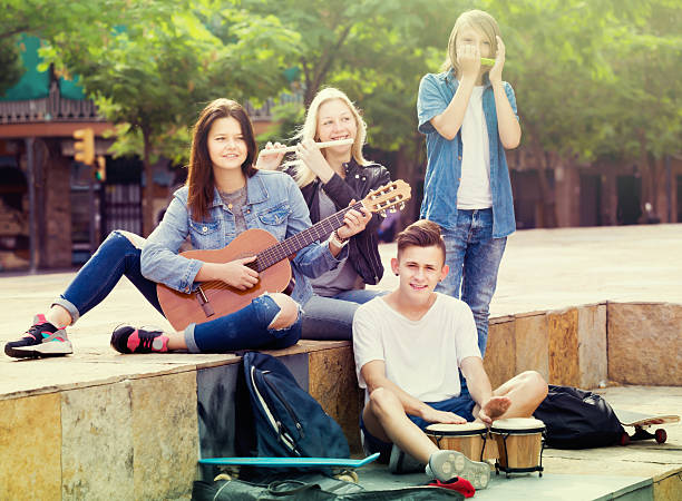 istock Glad girls and boys with musical instruments 636264612