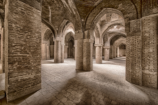 Inside Jameh Mosque of Isfahan, Iran. The Jāmeh Mosque is the grand, congregational mosque (Jāmeh) of Isfahān city. This is one of the oldest mosques still standing in Iran, it dates back to year 771.