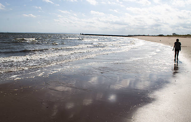 istock Little girl alon on the beach. 636267776