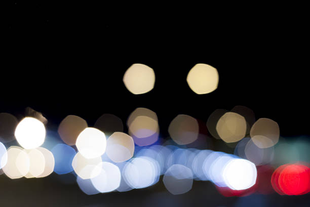 istock City traffic lights at night. Abstract blurry circles background 636267926