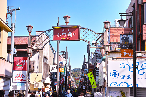 Kamakura, Japan - November 6, 2016: Scenery of Komachi Street in the center of Kamakura city. In Komachi-dori, there used to be electric wires long before, but in recent years the electric wires were removed to improve the landscape. There are various shops in this street. A lot of people are overflowing on holidays.