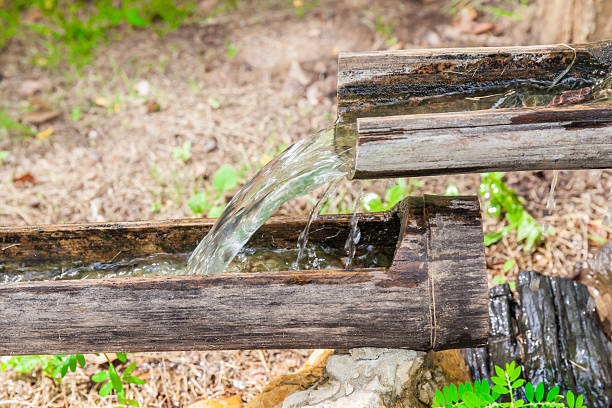 istock Water line from steps of natural bamboo pipes. 636269530