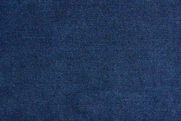 Dark blue jeans texture close up with horizontal thread lines