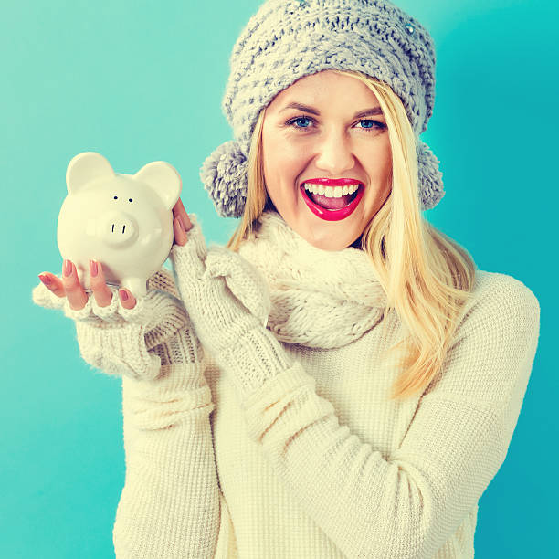 istock Young woman with a piggy bank 636270220