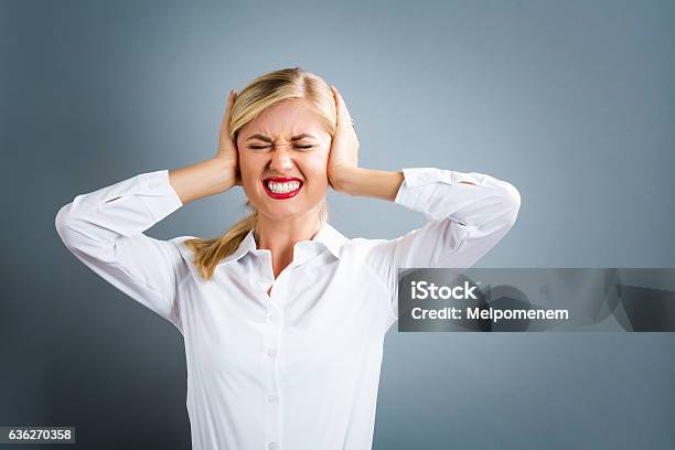 Young Woman Blocking Her Ears Stock Photo - Download Image Now - Fingers in Ears, Only Women, Women