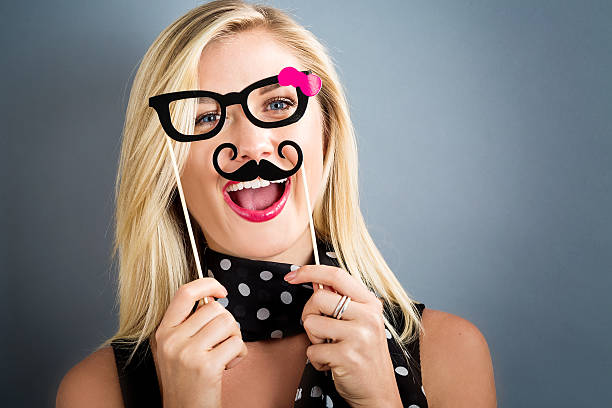 istock Young woman holding paper party sticks 636270564