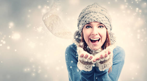 istock Happy young woman blowing snow 636270886
