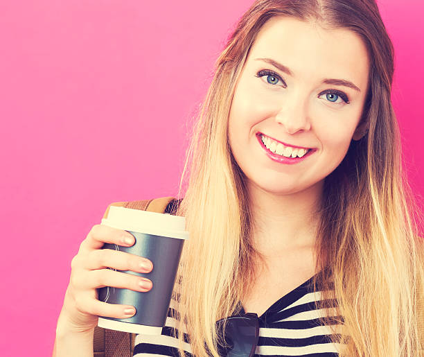 istock Happy young woman drinking coffee 636271042