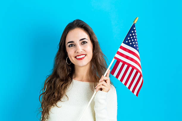 istock Young woman holding American flag 636271162