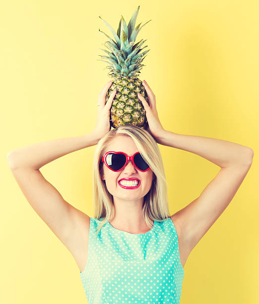 istock Happy young woman holding a pineapple 636271582