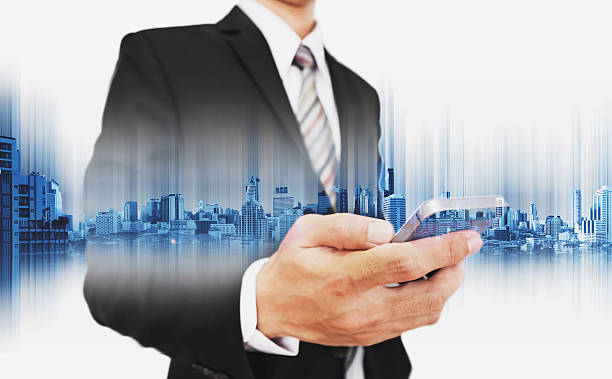 istock Businessman using smartphone, with double exposure city, business communication technology 636275158