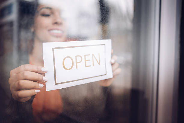 istock Women hold a sign open 636275826
