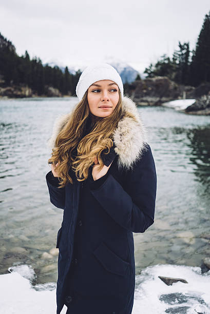 istock Beautiful girl along the river in winter 636275908