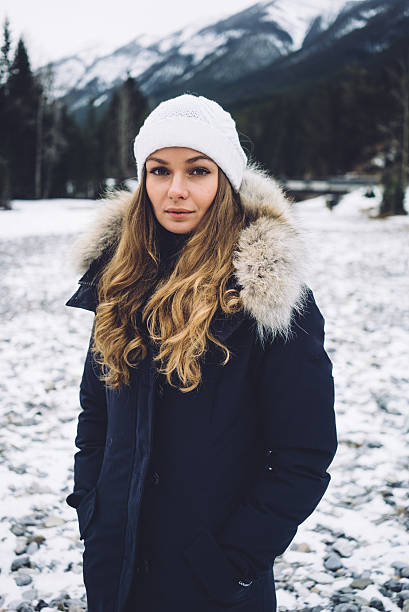 istock Beautiful girl along the river in winter 636275938