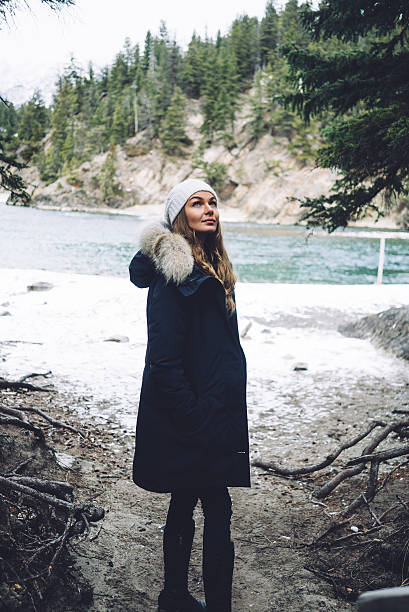 istock Beautiful girl along the river in winter 636275974